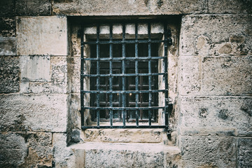 Fototapeta na wymiar Ancient window with grating