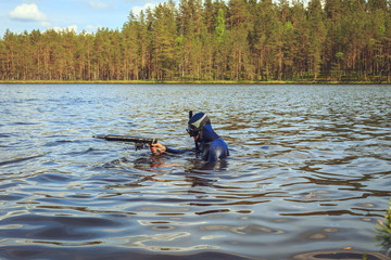 Fototapeta na wymiar Underwater hunter preparing to dive.