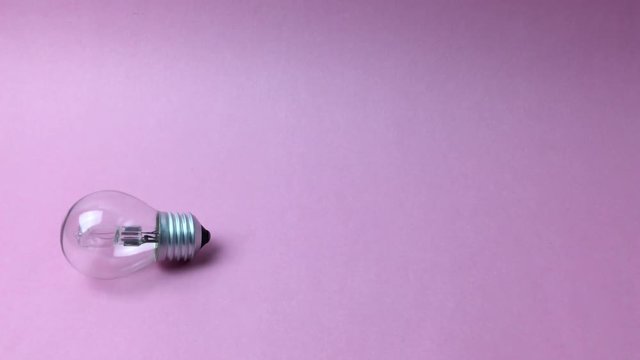 Bombilla moviendose a la derecha sobre fondo rosa.