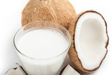 coconut oil and fresh coconuts isolated on white background