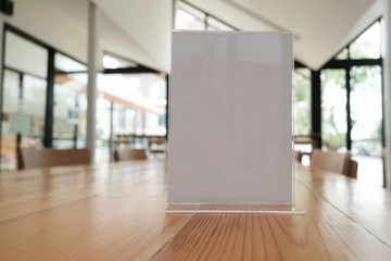 white label in cafe. display stand for acrylic tent card in coffee shop. mockup menu frame on table in restaurant. space for text