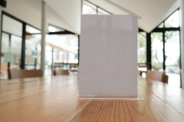 white label in cafe. display stand for acrylic tent card in coffee shop. mockup menu frame on table...