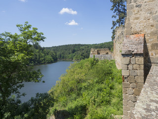 Fototapeta na wymiar view from rampart of medieval castle Zvikov (Klingenberg), stone wall, vltava river, spring green trees and blue sky, Czech Republic