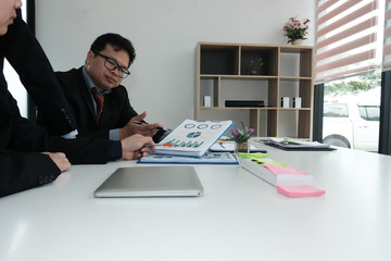 business adviser analyzing company financial report. professional investor discussing idea. businessman working on startup project with co working team.