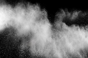 Bizarre forms of  white powder explosion cloud against dark background. Launched white particle splash on black background.