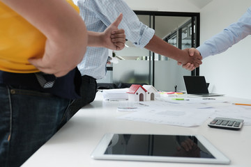 architect & customer shaking hands. Engineer handshaking with partner for successful deal in building project development. business teamwork concept