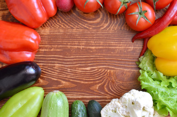 vegetables tomatoes cucumbers peppers on brown background