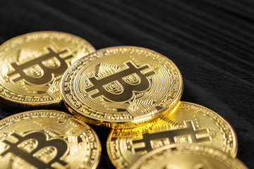 Gold Bitcoin money on wooden table. Electronic crypto currency