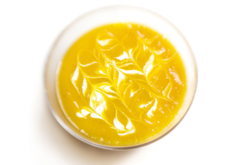 Pumpkin soup with cream on white background
