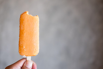 Orange bitten ice pop or popsicle
