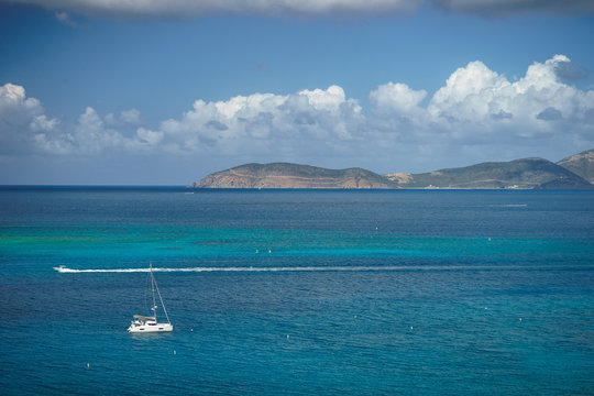Beautiful sea with yacht and small islands on background