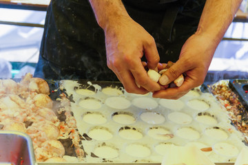 Closeup man make takoyaki