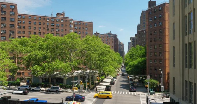 A daytime high angle establishing shot view of traffic along 10th Avenue and West 26th Street in midtown Manhattan.  	