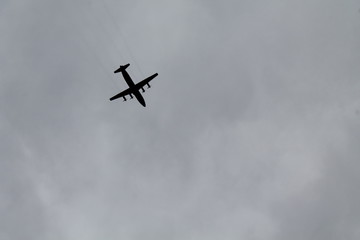 Fototapeta na wymiar the plane on a background cloudy sky