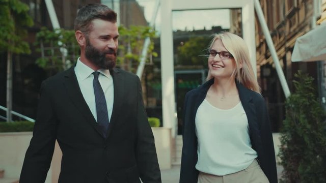 Portrait business man and woman talking walking smiling together at outdoor happy handsome internet technology pair team corporate executive city outside urban work young teamwork worker