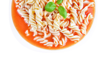 Traditional homemade tomato soup with noodles on white plate. Top view with copy space. Polish food