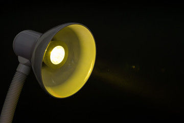 table lamp with yellow diode bulb on black background