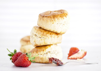 Cream Tea - scones with jam, cream and strawberrys on a white background