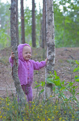 Little girl is walking alone in the forest
