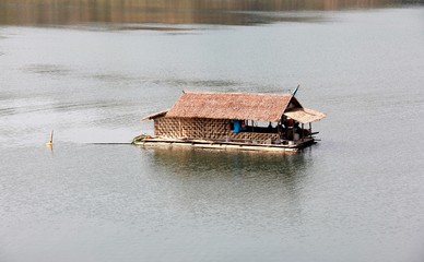 a bamboo hut is floating on the river