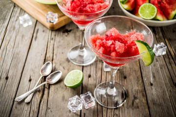 Sweet summer watermelon and lime granita with sliced watermelon and mint, on white marble background copy space