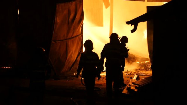 Team Of Firefighters Trying To Put Down A Fire
