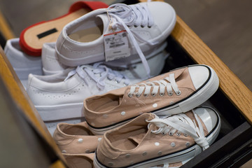 Shoes for sale at shop- Pile of assorted footwear in mall