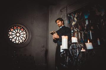 Fototapeta na wymiar Priest reading and praying in the church