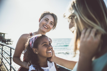 happy gay couple spending time together with their adopted daughter
