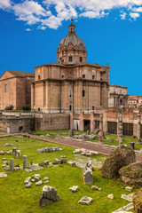 Fototapeta na wymiar Roman Forum in Rome, Italy. Rome Forum at summer day with blue sky and clouds