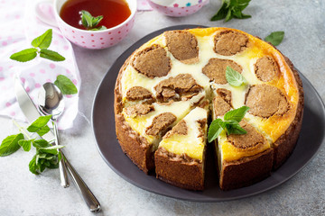 Cheesecake and mint tea cup. Chocolate New York cheesecake and mint tea cup on concrete background.