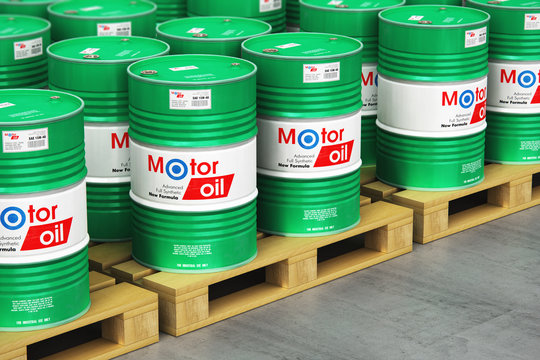 Group of barrels with motor oil lubricant on shipping pallets in warehouse