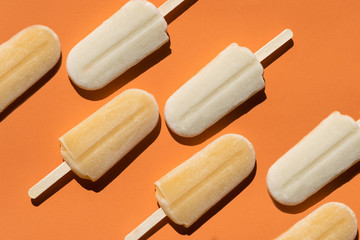 Varying  popsicles on an orange background. Flat lay of ice creams  in pop-art style. Horizontal  format