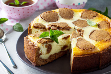 Cheesecake and mint tea cup. Chocolate New York cheesecake and mint tea cup on concrete background.