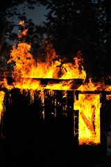 Old wooden shed on fire