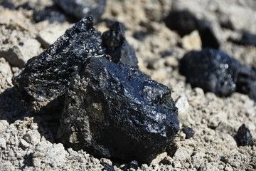 Oil / tar spill on a clean spot of soil