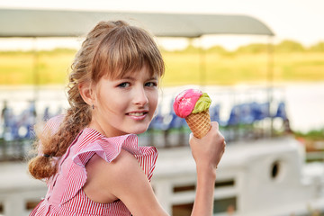 Happy smiling girl holding sweet ice cream. Portrait child teenager 11 years, elegant lady, outdoors summer. Caucasian face, clean skin. Delicious cold dessert in a waffle horn.