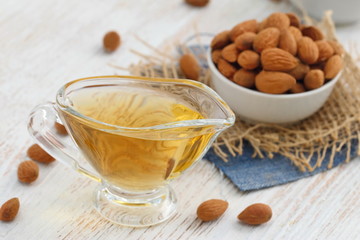 Almond nuts in a bowl and almond oil