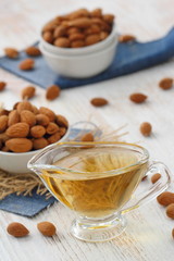 Almond nuts in a bowl and almond oil