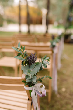 Wooden chairs for guests at a wedding ceremony