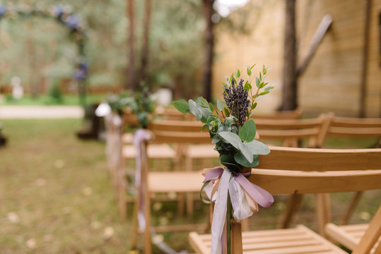 Wooden chairs for guests at a wedding ceremony