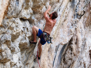 Young strong guy climbing / leading topless in Thailand - Krabi, Tonsai Beach