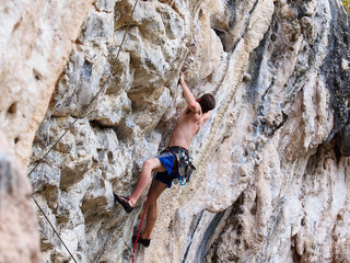Young strong guy climbing / leading topless in Thailand - Krabi, Tonsai Beach