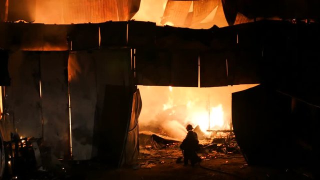 Two Fireman Extinquishing A Fire