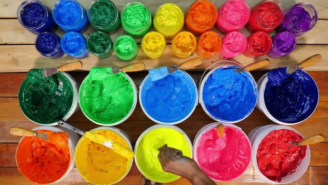 colorful Plastisol ink on pine wood table. Plastisol ink useful in tee shirt factory and in industry for export