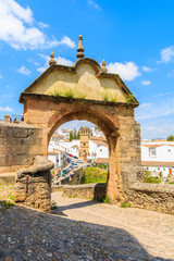 Castle gate and view of white houses in Andalusian village of Ronda, Spain