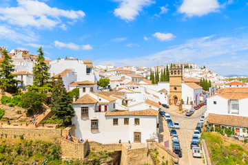 Fototapeta na wymiar Church building on square and white houses in Andalusian village of Ronda, Spain