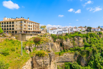 Fototapeta na wymiar Historic buildings and white houses on cliff in Andalusian village of Ronda, Spain
