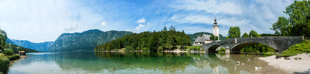 Fototapeta na wymiar Reflection of the Holy spirit Church, lake Bohinj Slovenia. Panorama