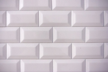 Ceramic rectangular white tile laid horizontally. Glazed white ceramic brick for interior walls